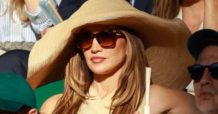 Jennifer Lopez wearing a large sun hat and sunglasses at Wimbledon