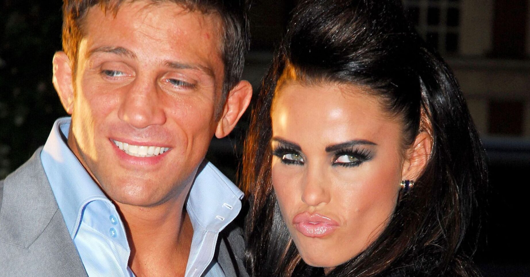 Alex Reid grinning beside a frowning Katie Price