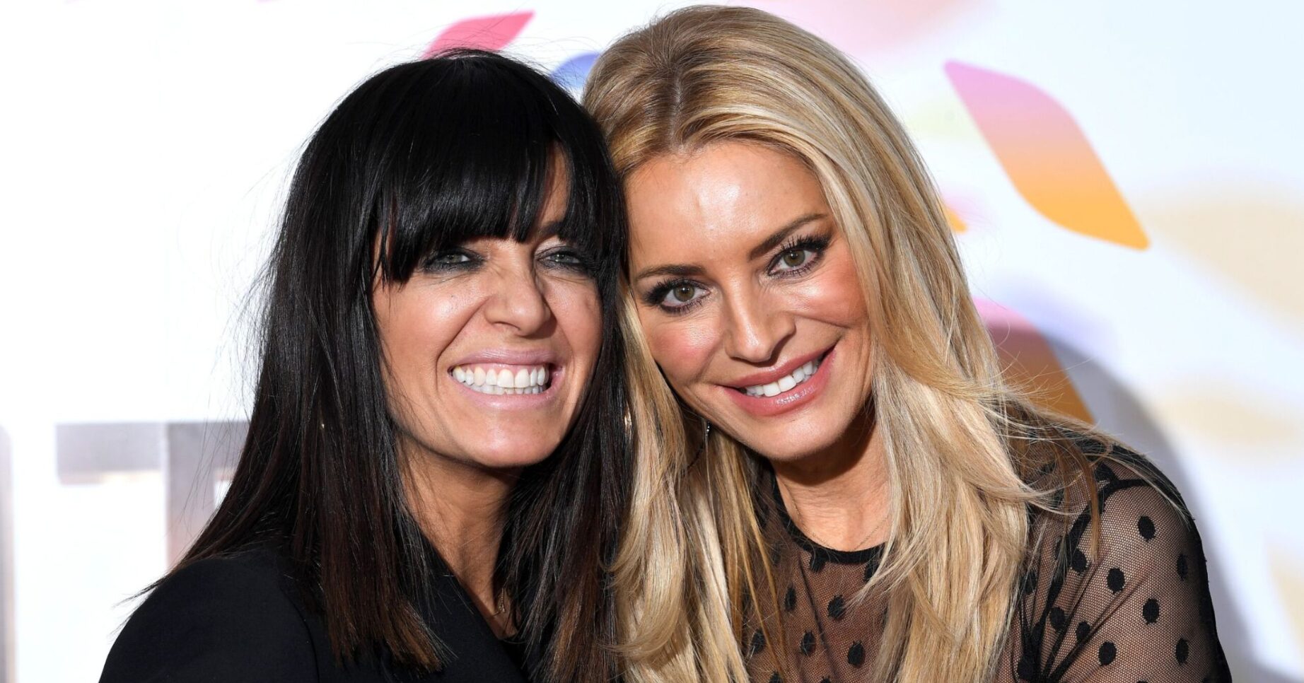 Claudia Winkleman smiling beside Tess Daly