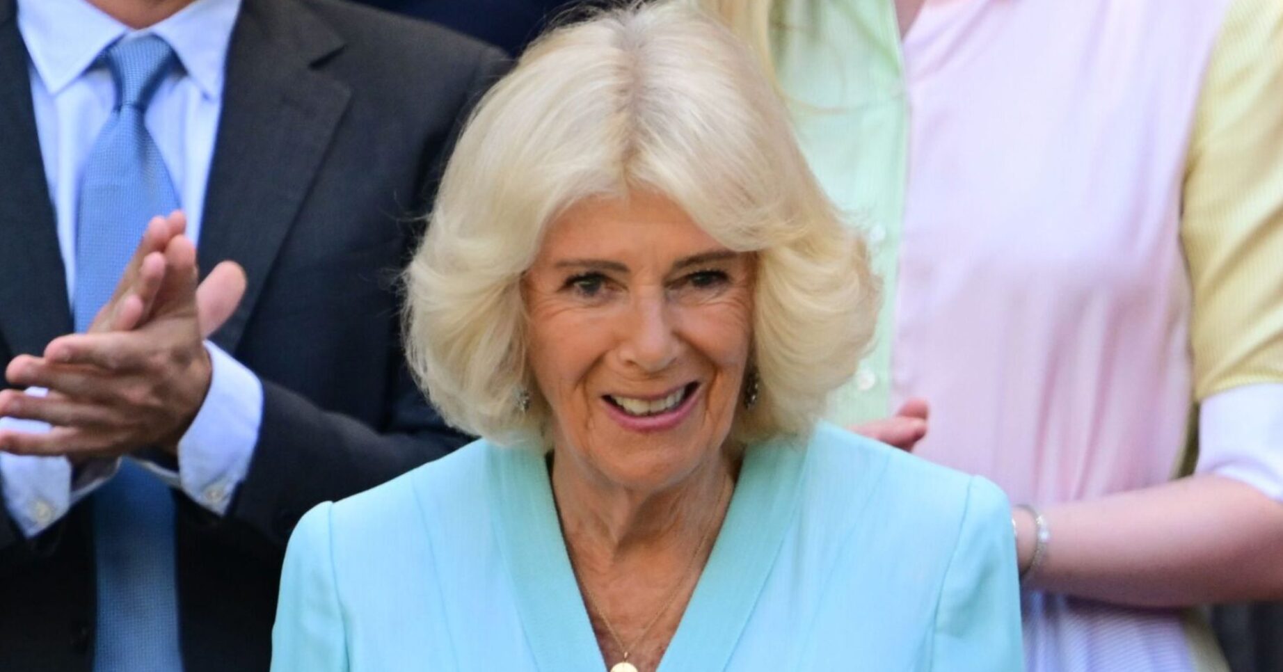Queen Camilla smiling wearing blue at Wimbledon