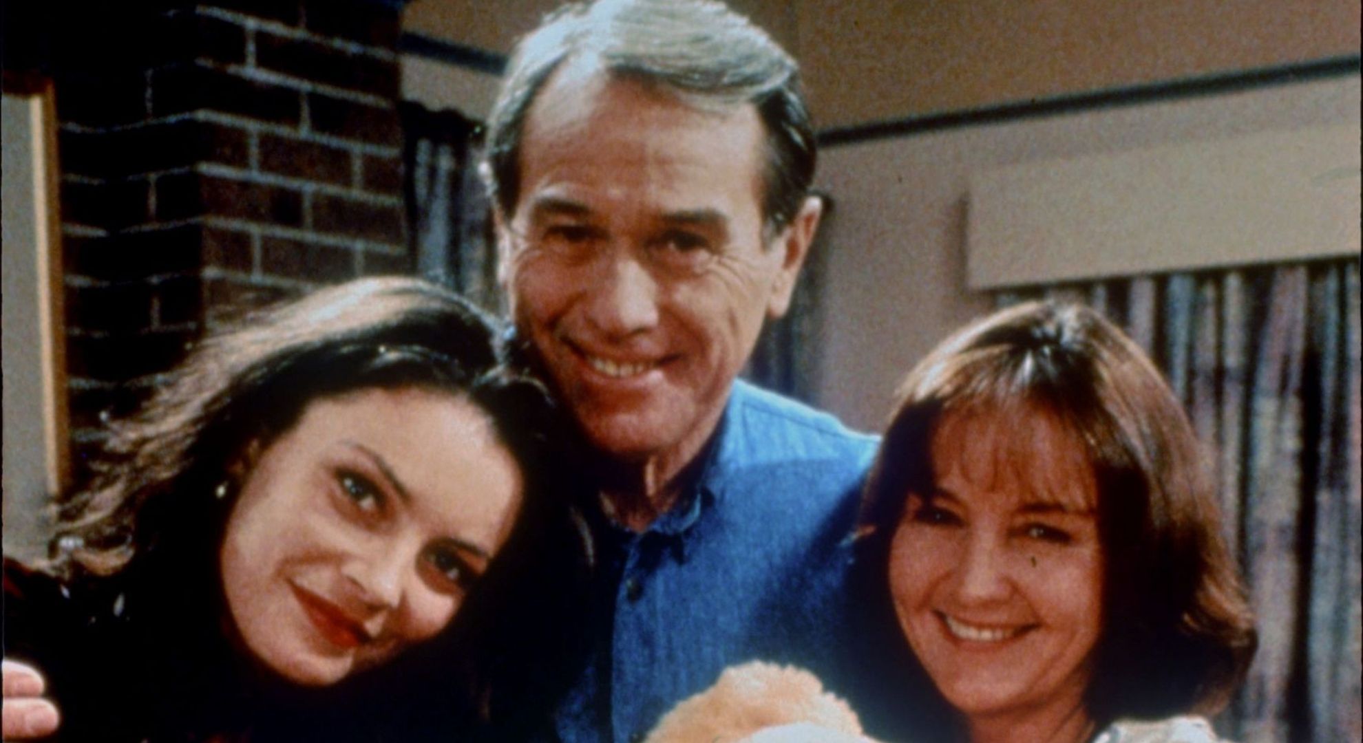 Terence Donovan smiling with co-stars on set of Neighbours