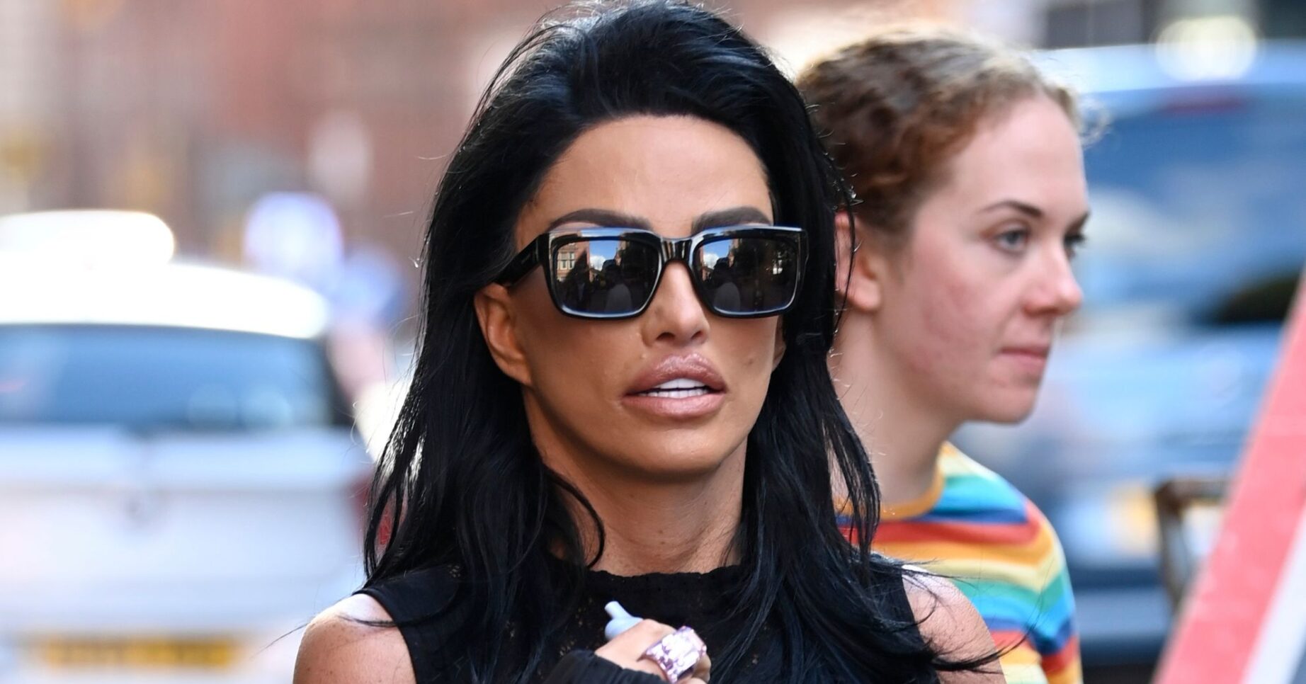 Katie Price wearing sunglasses and frowning