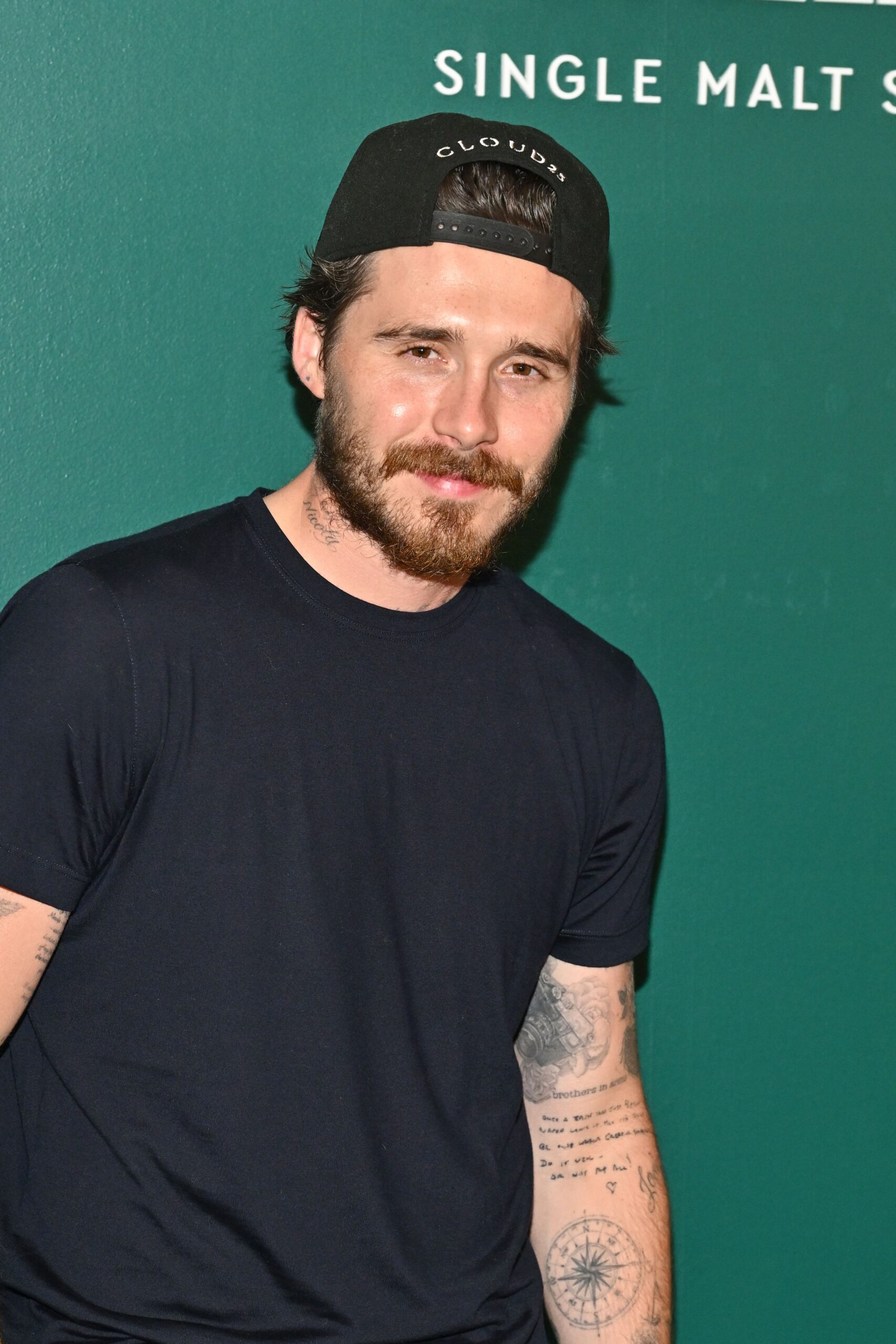 Brooklyn Beckham smiling at event