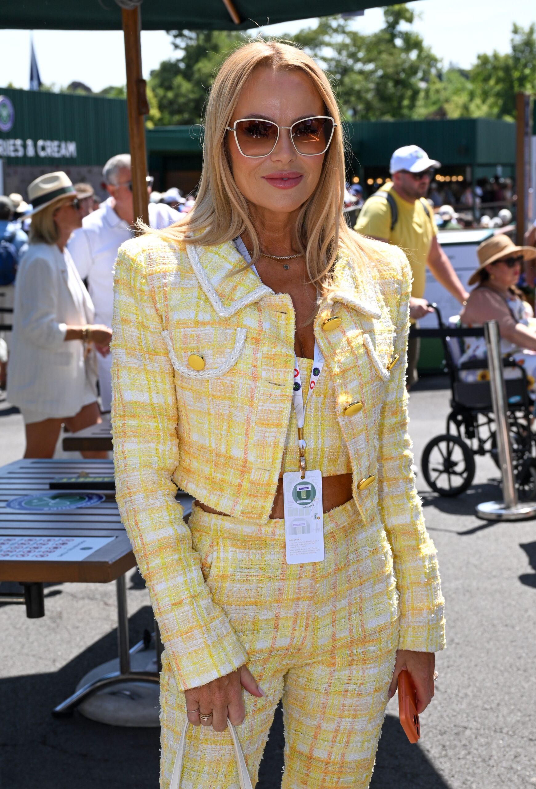 Amanda Holden smiling in yellow outfit at Wimbledon Tennis Championships