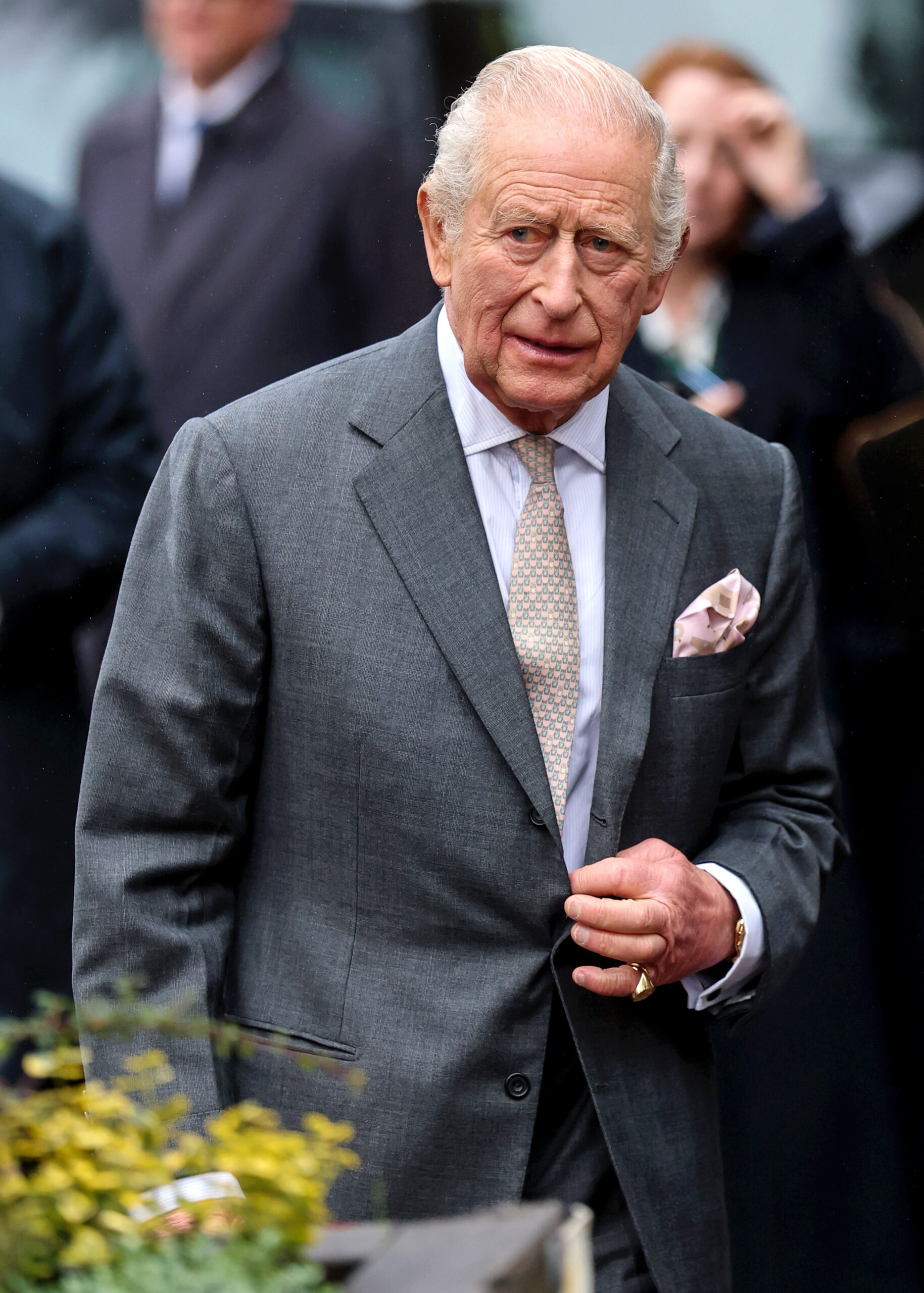 King Charles looking worried in grey suit