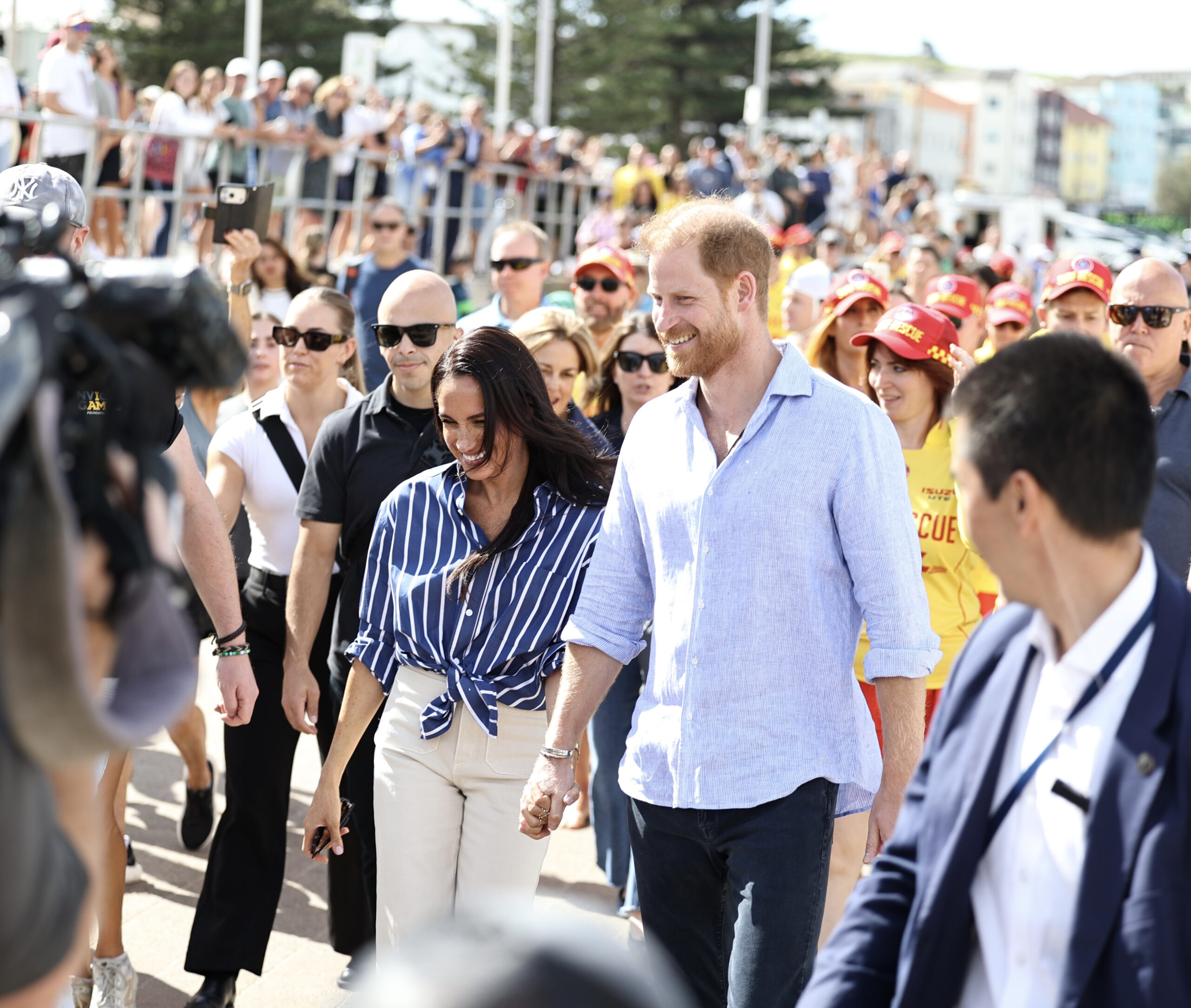 Meghan and Prince Harry heading through the crowd in Sydney