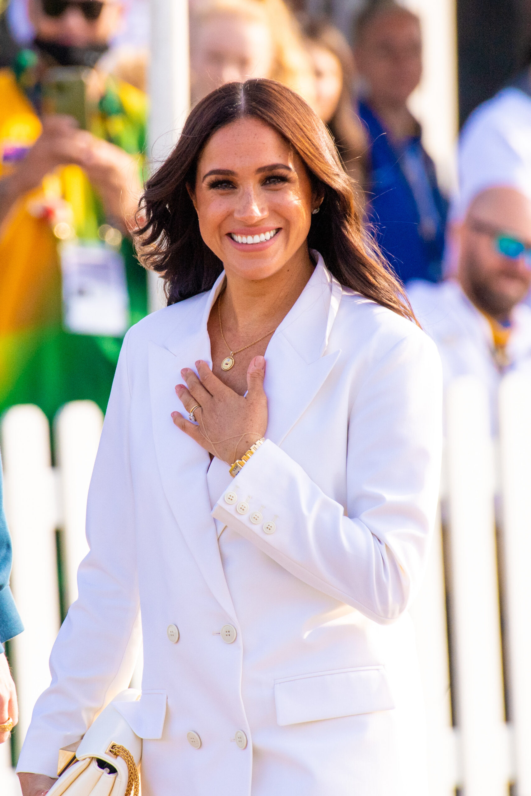 Meghan Markle smiling in white outfit
