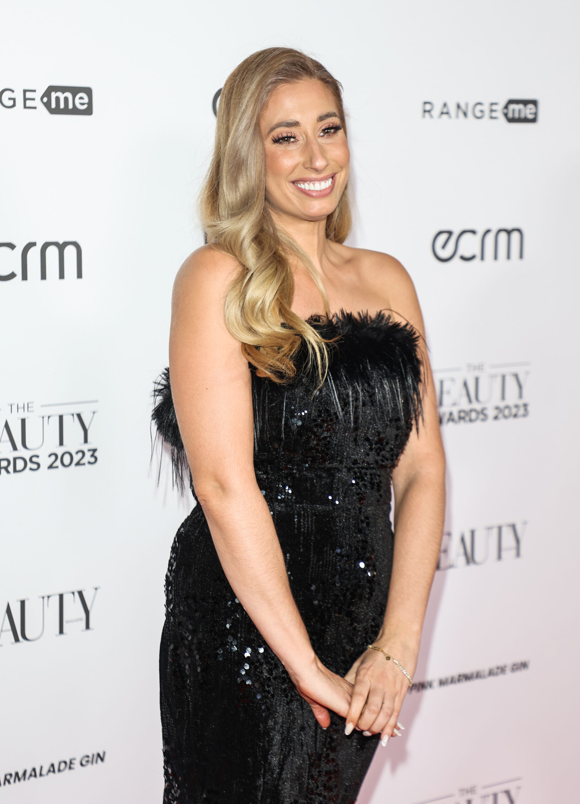 Stacey Solomon smiles in black dress at event