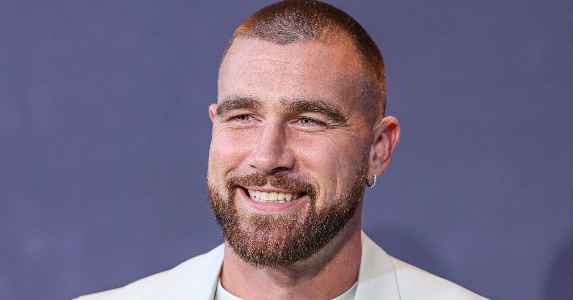 Travis Kelce smiling at event