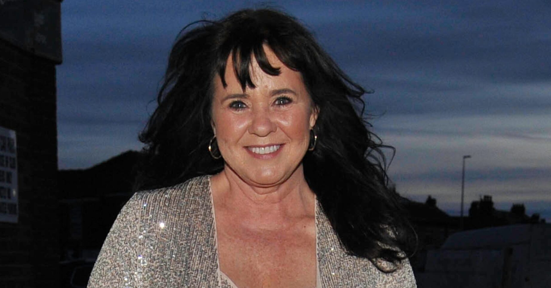 Coleen Nolan smiling in glittery top