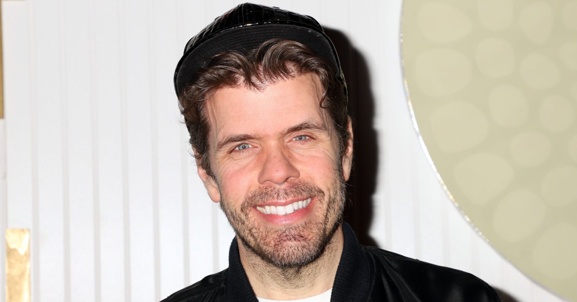 Perez Hilton smiling at event