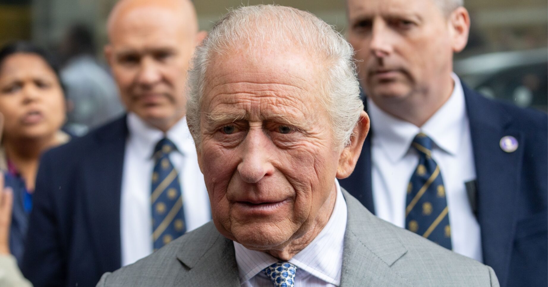 King Charles looking concerned in suit