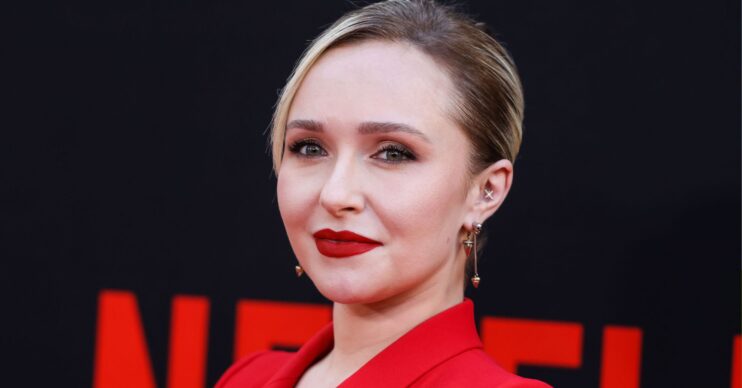 Hayden Panettiere wears red lipstick and a red blazer.