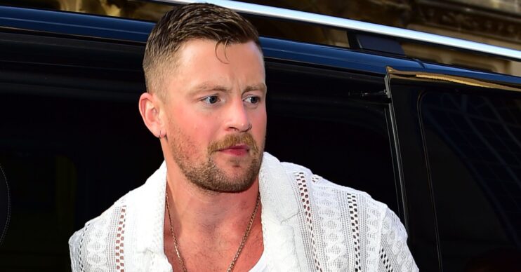 Adam Peaty getting out of a car