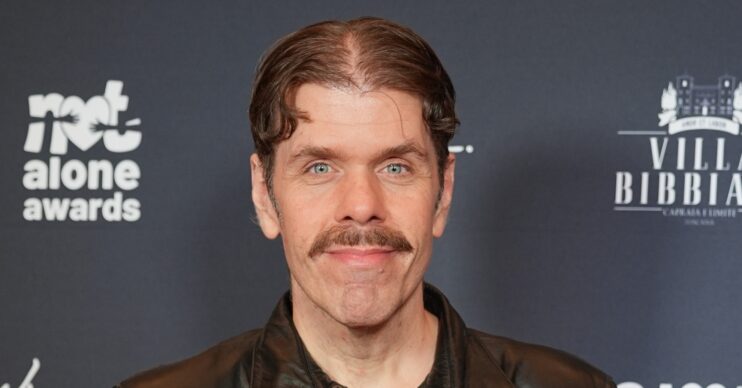 Perez Hilton smiling at event