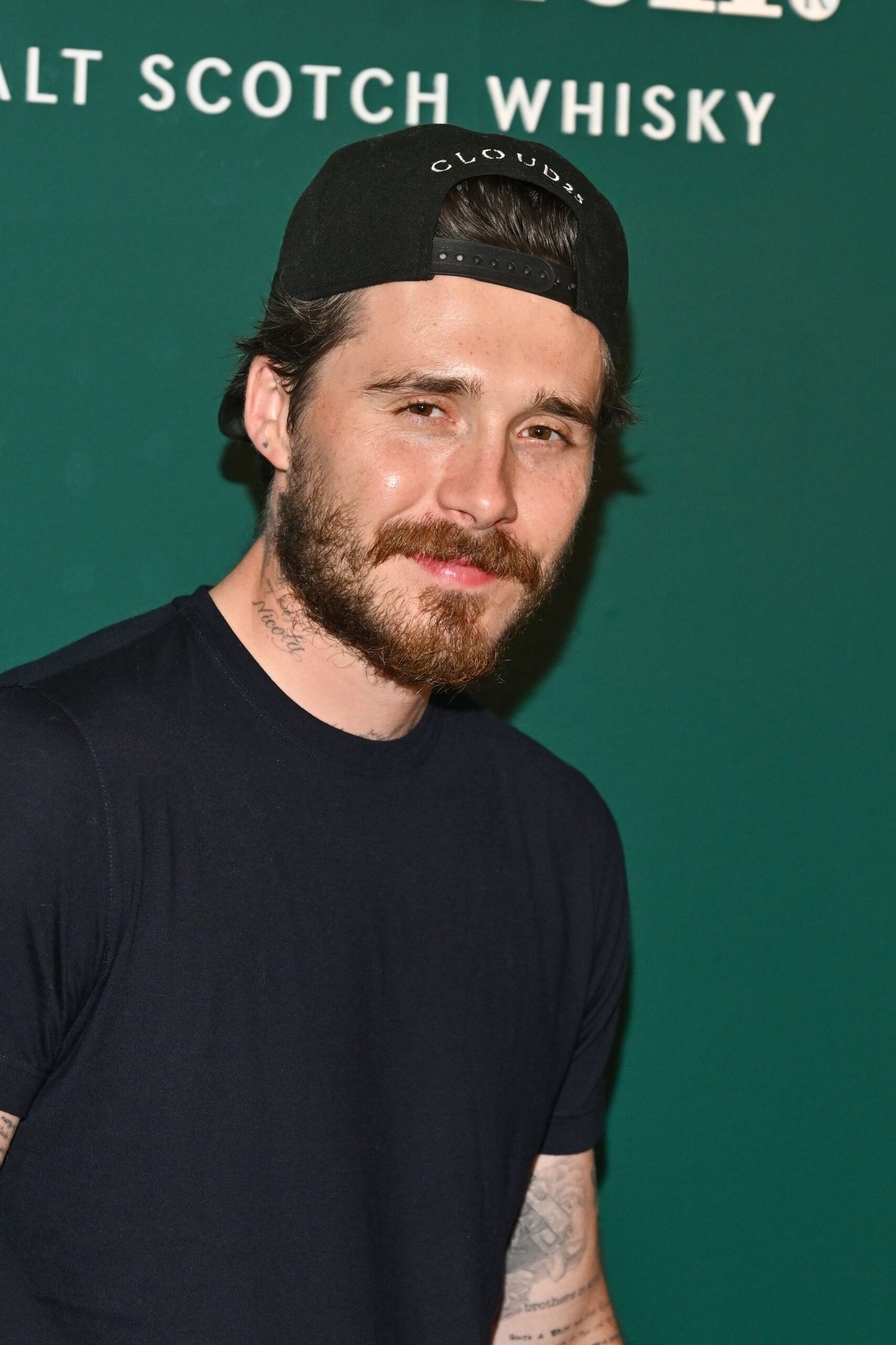 Brooklyn Beckham smiling at event