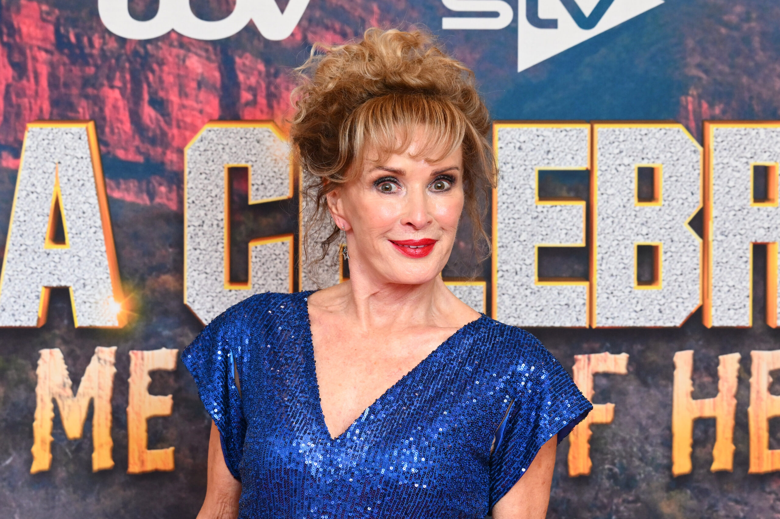 Beverley Callard smiling wearing a blue dress