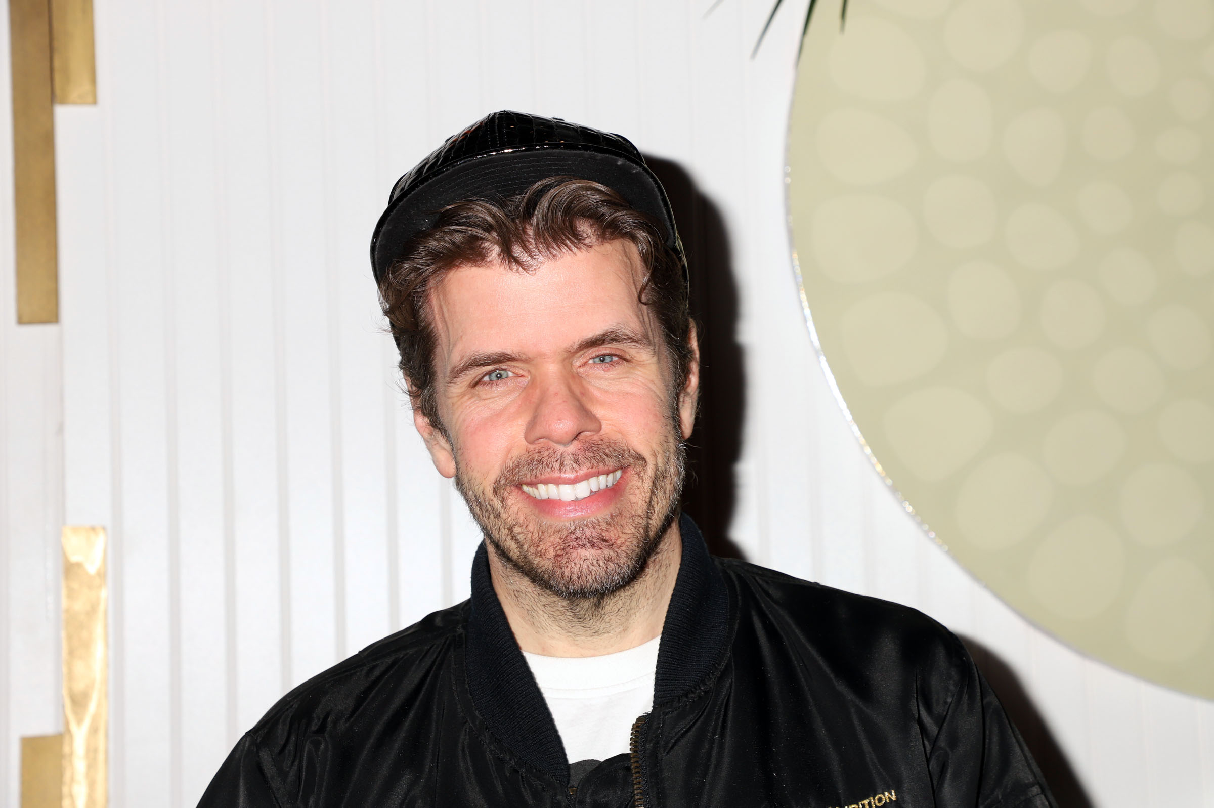 Perez Hilton smiling at event