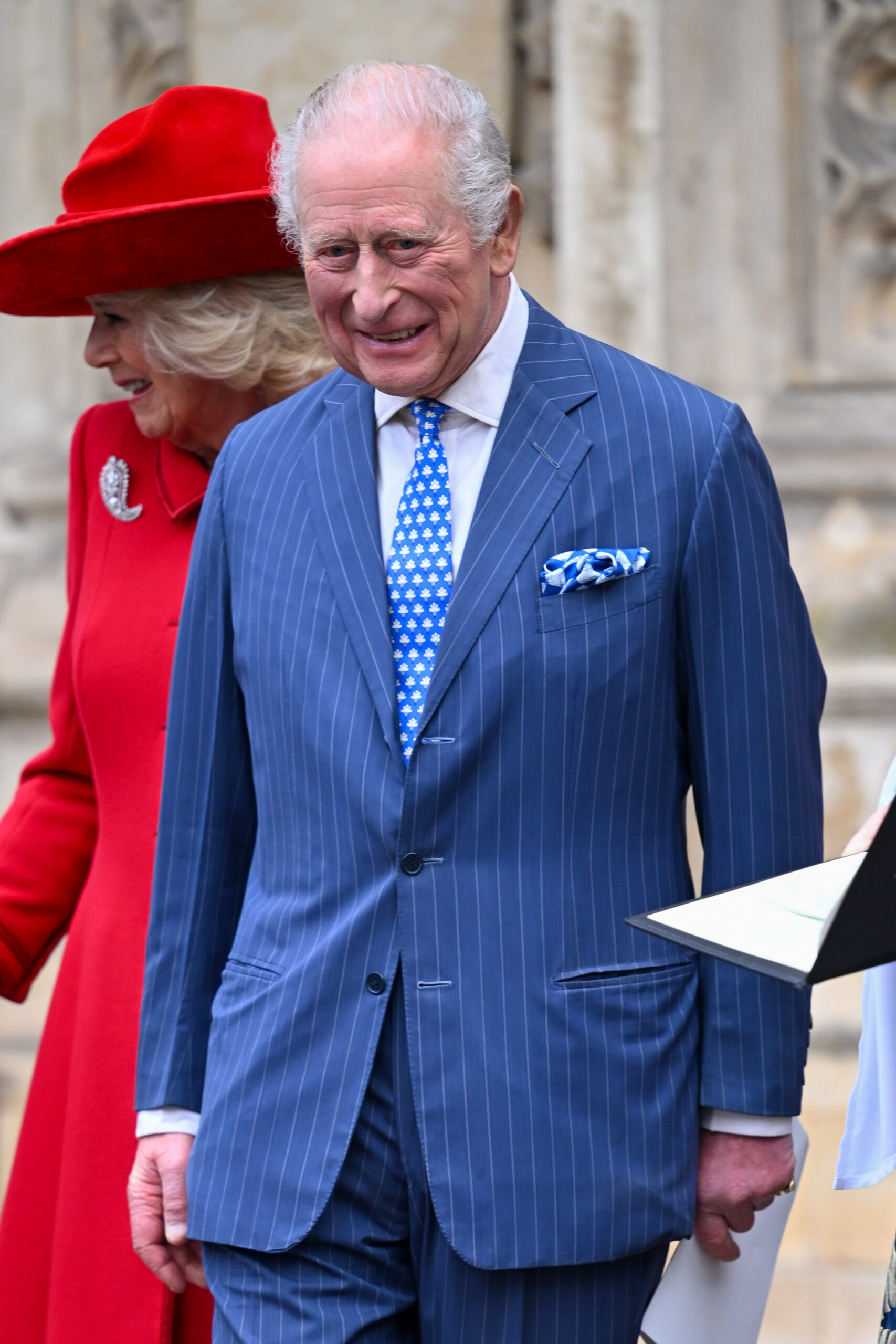 King Charles smiling in blue suit