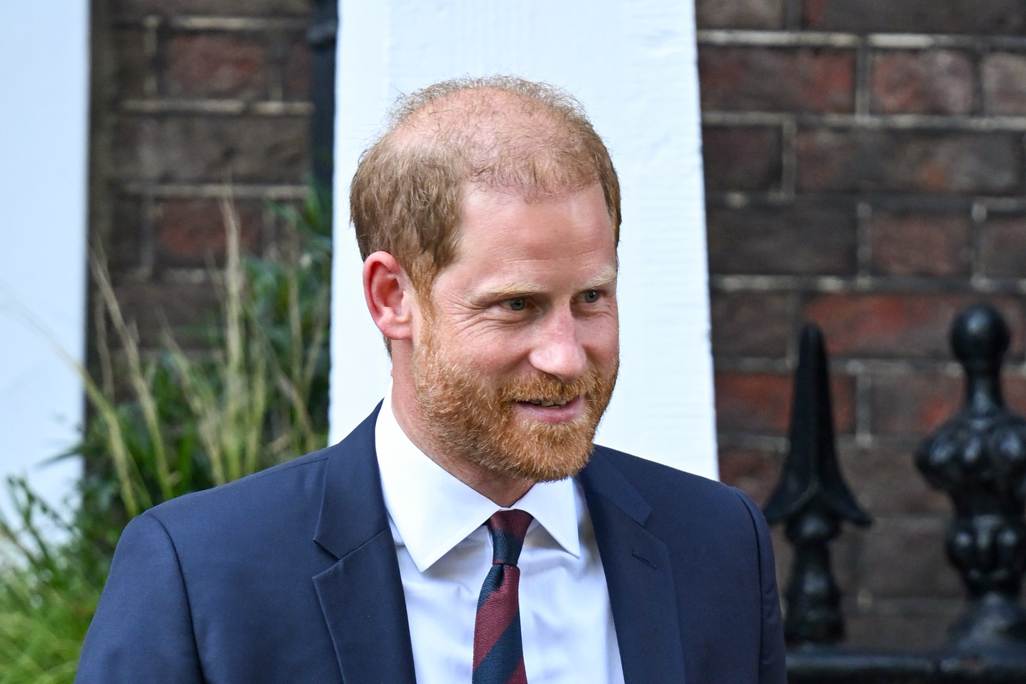 Prince Harry smiling in navy suit