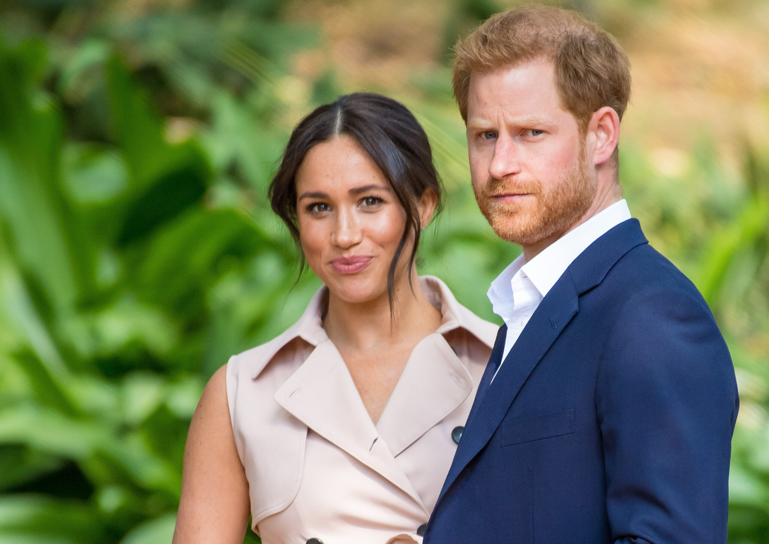 Meghan Markle and Prince Harry smiling at camera