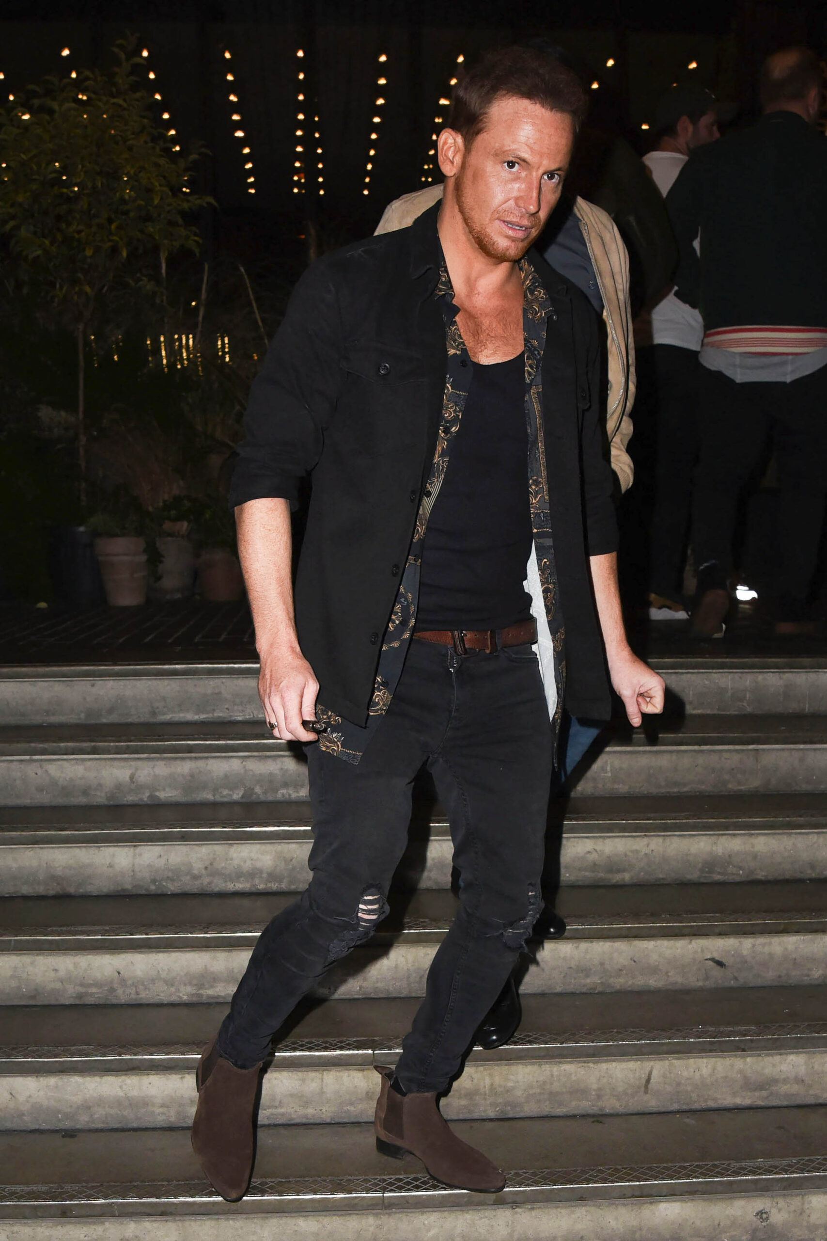 Joe Swash walking down stairs 