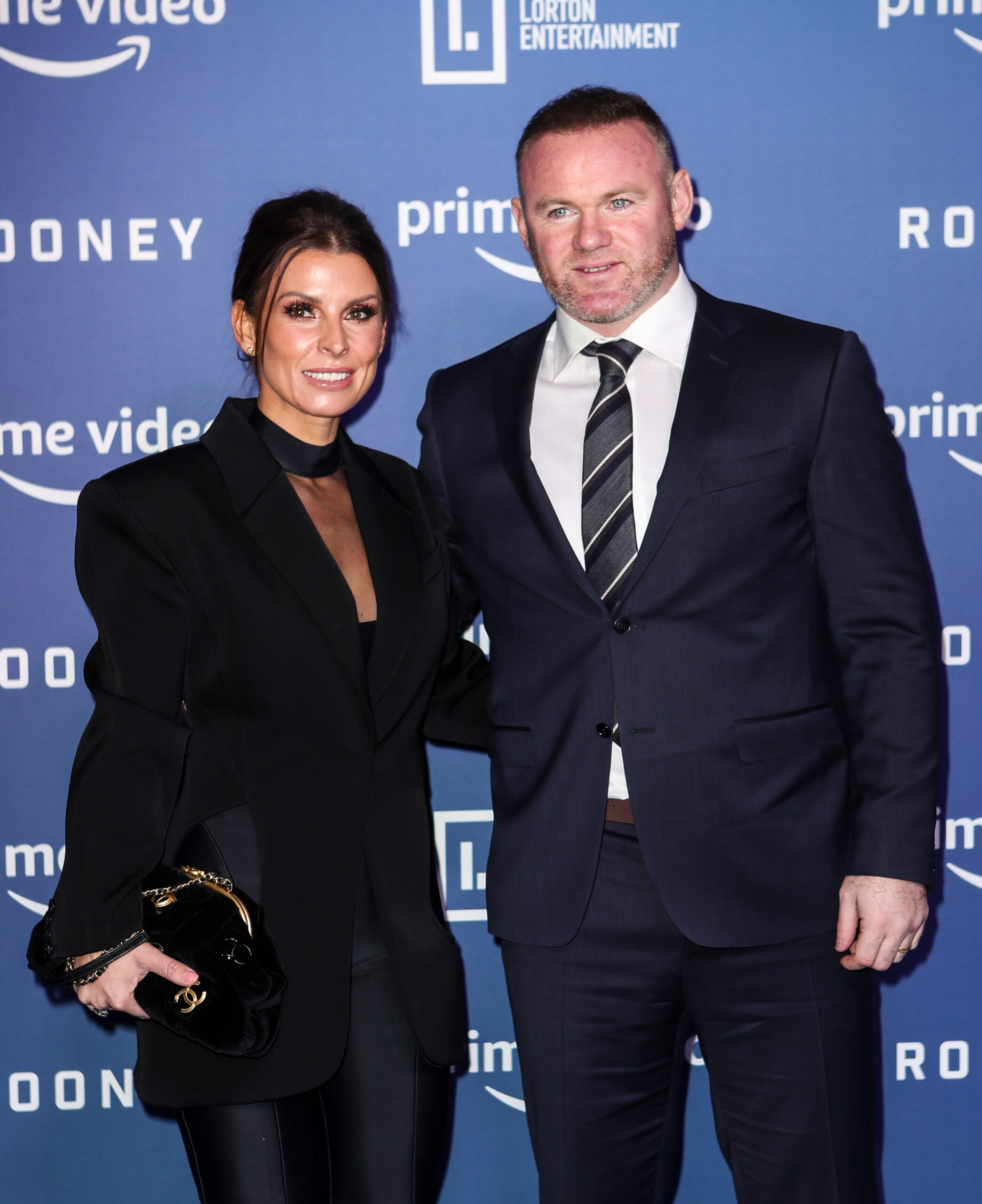 Coleen and Wayne Rooney smiling at event