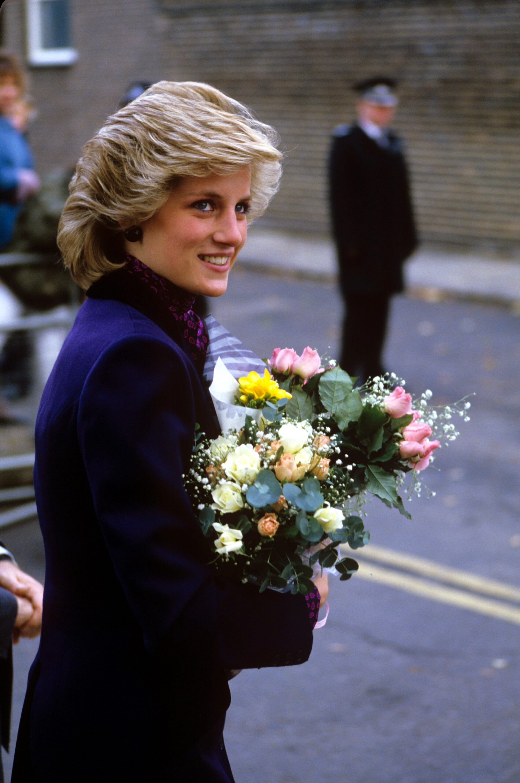 Princess Diana smiling with flowers