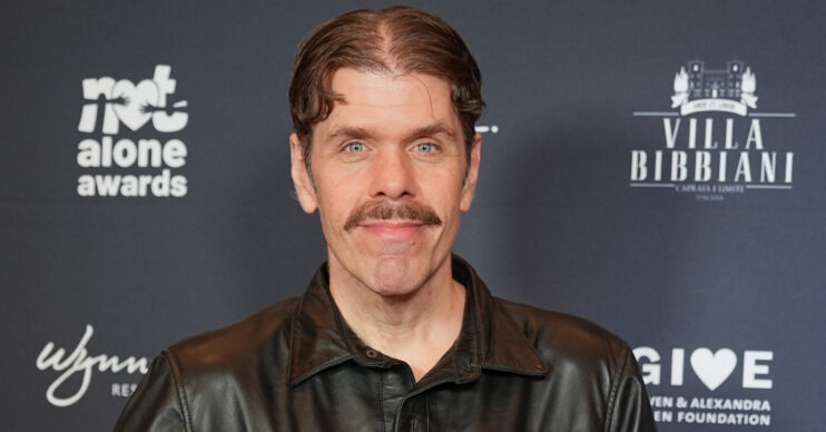 Perez Hilton smiling at event