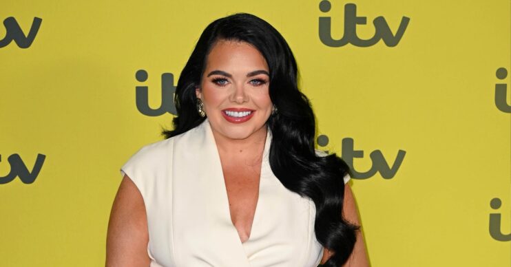 Scarlett Moffatt on the red carpet in a white dress