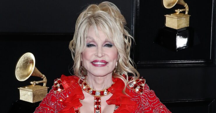 Dolly Parton smiling in red dress