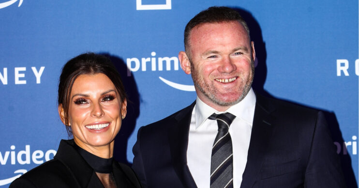 Coleen and Wayne Rooney smiling at event