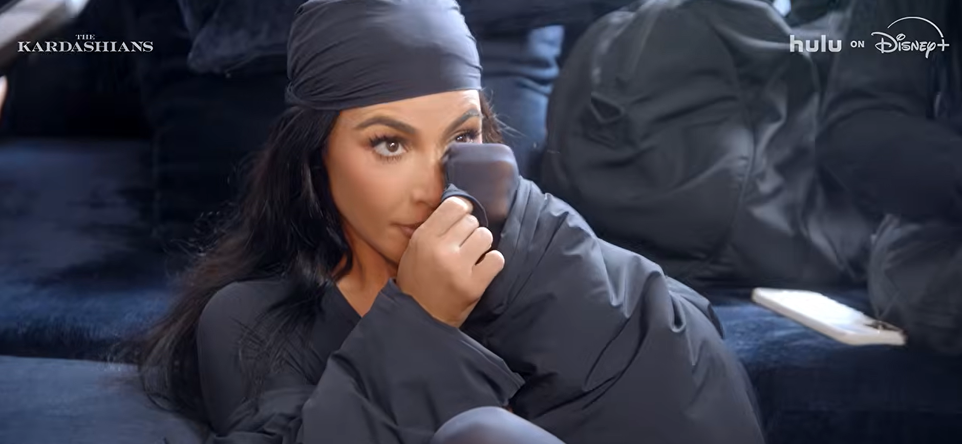 Kim Kardashian wipes her tears.
