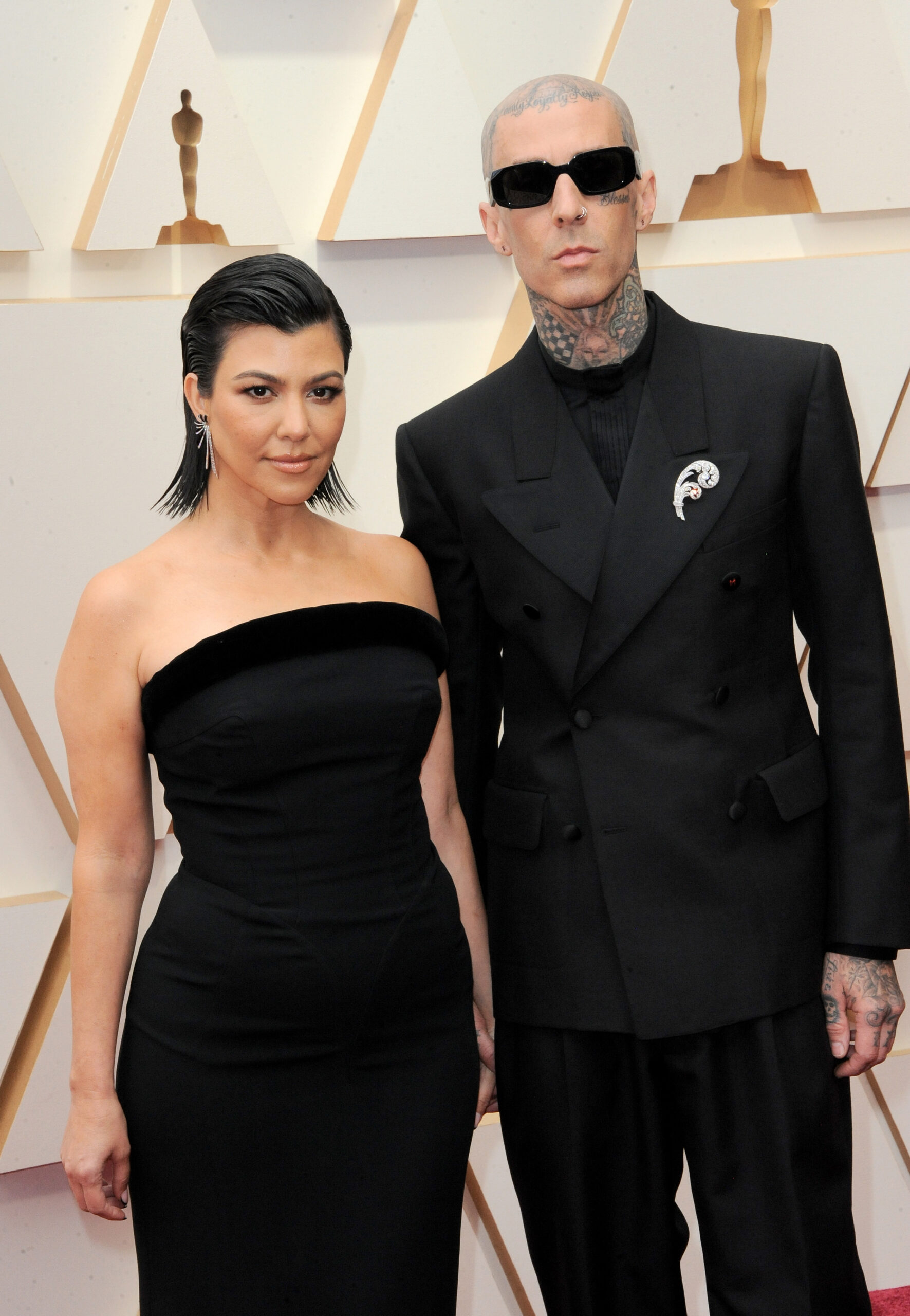 Kourtney Kardashian poses on the red carpet with Travis Barker