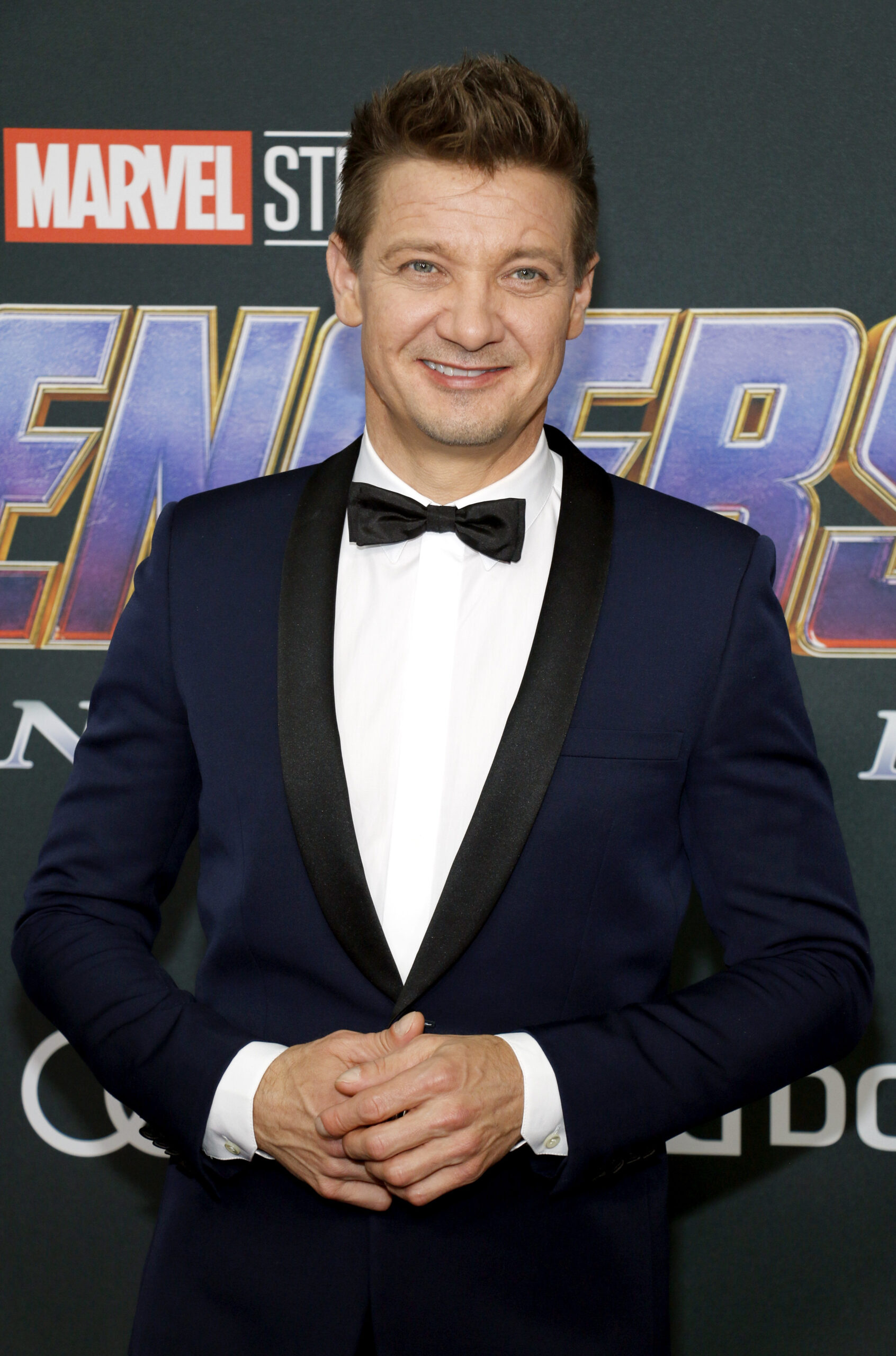 Jeremy Renner poses on the red carpet in a tux