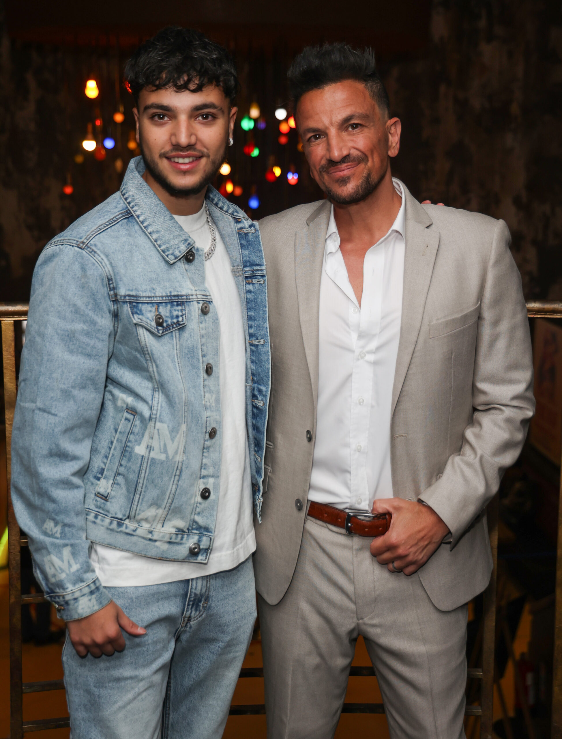 Peter Andre and son Junior smiling at event