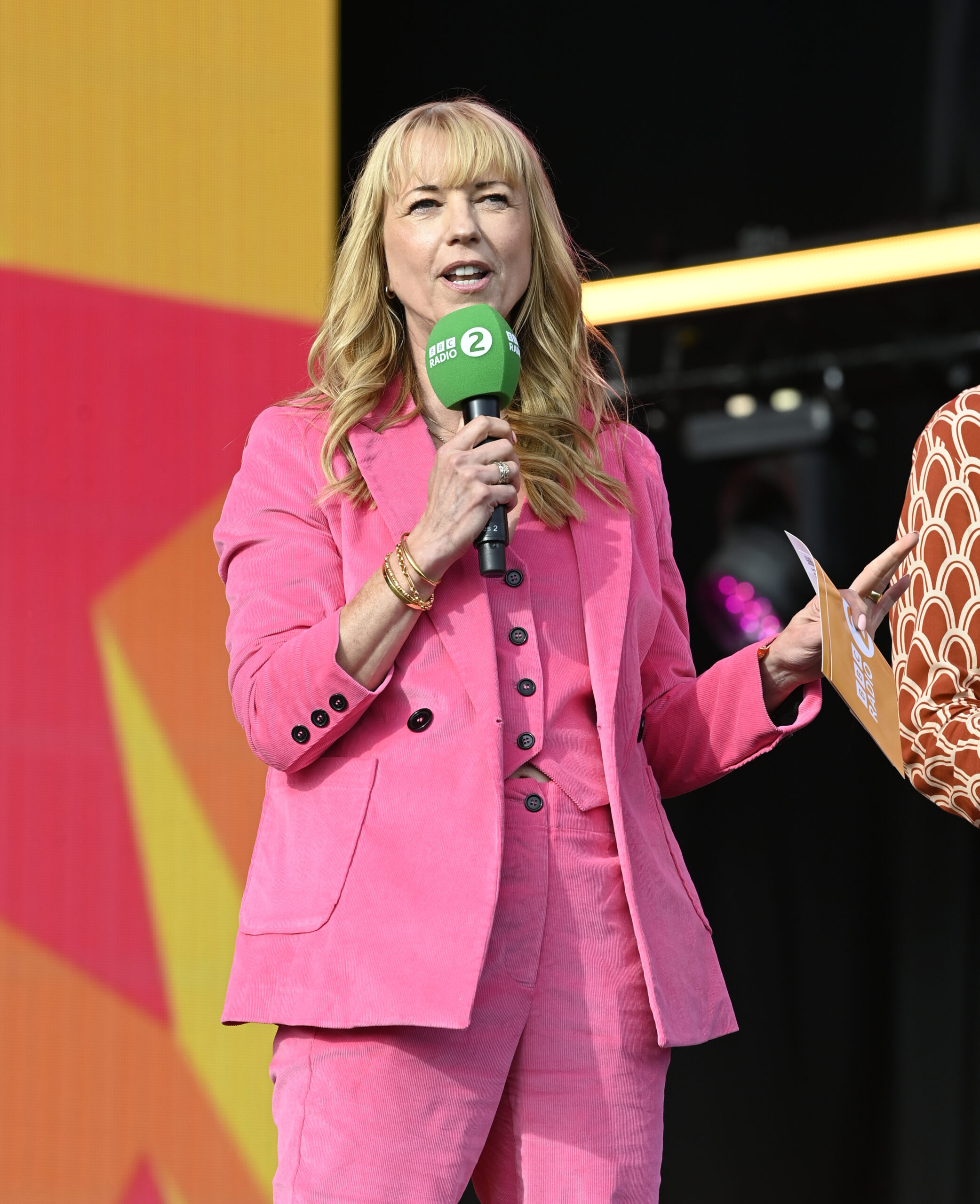 Sara Cox holding microphone