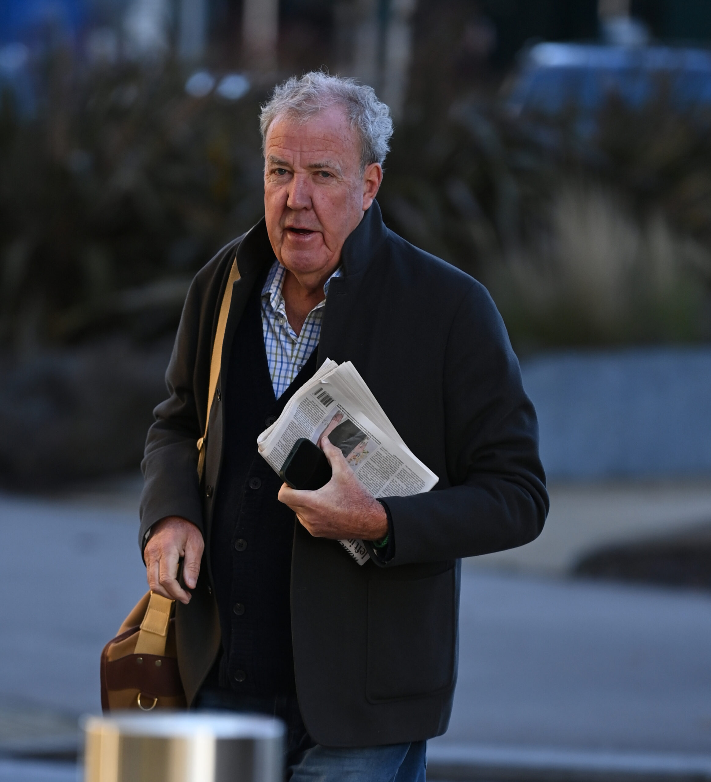 Jeremy Clarkson carrying newspaper and bag