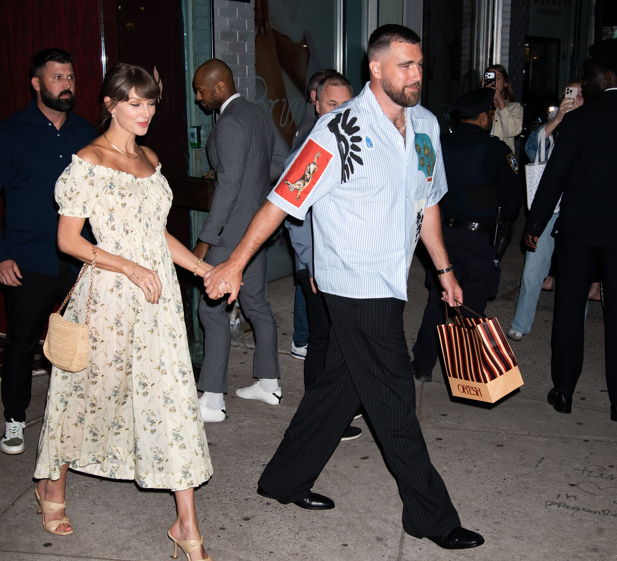 Travis Kelce and Taylor Swift hold hands