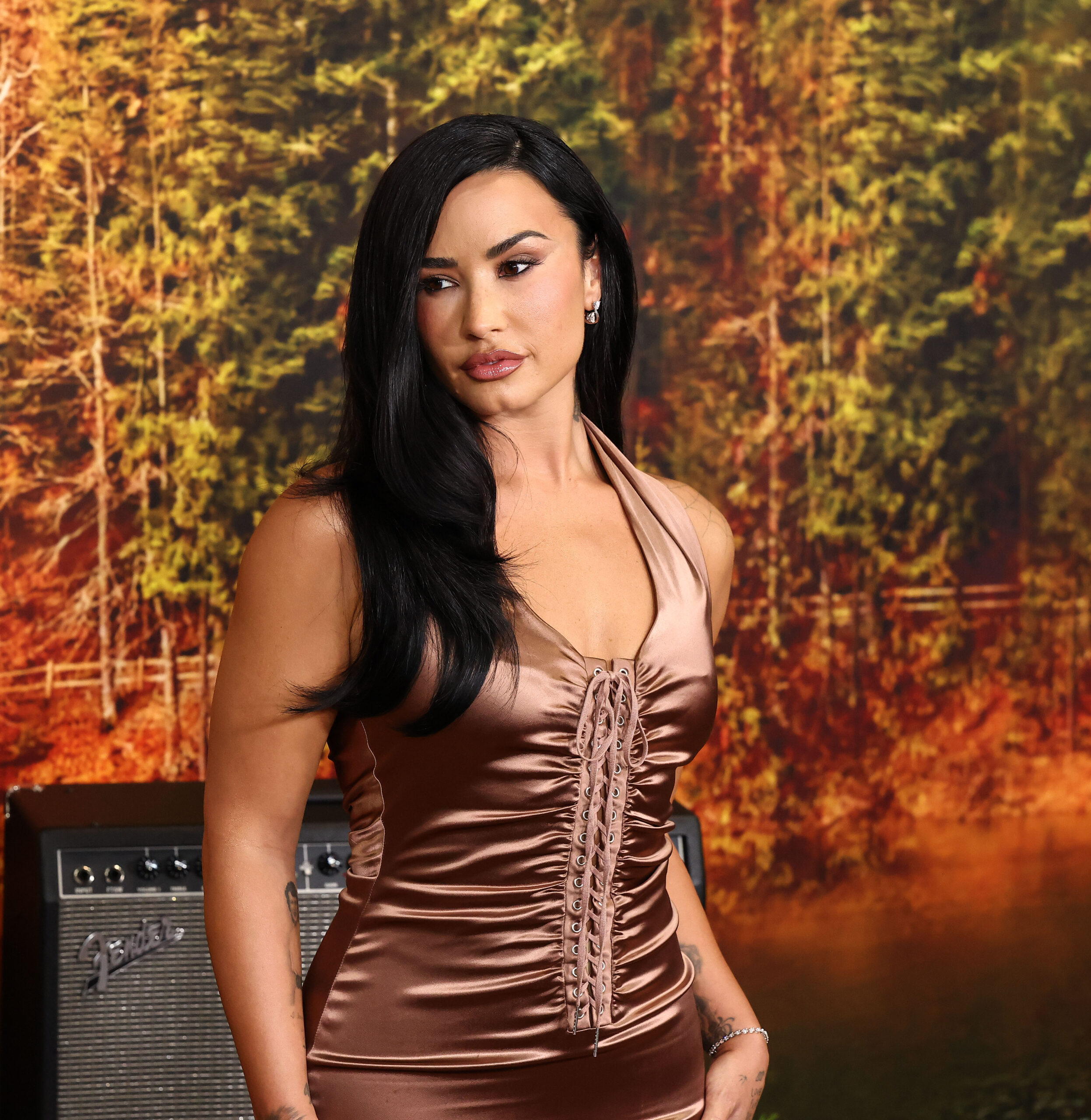 Demi Lovato wears a caramel coloured dress