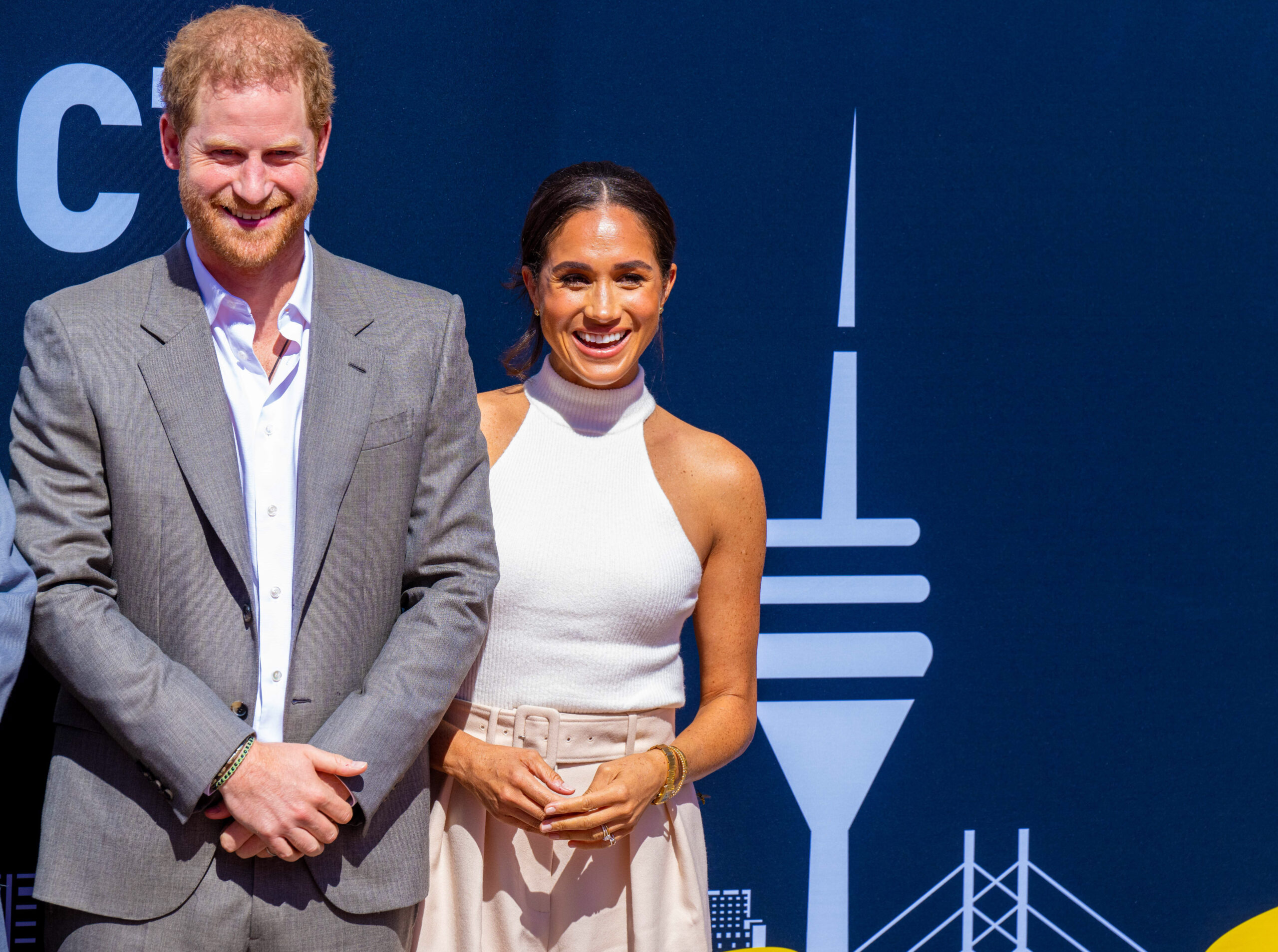 Prince Harry and Meghan Markle pose together at an event