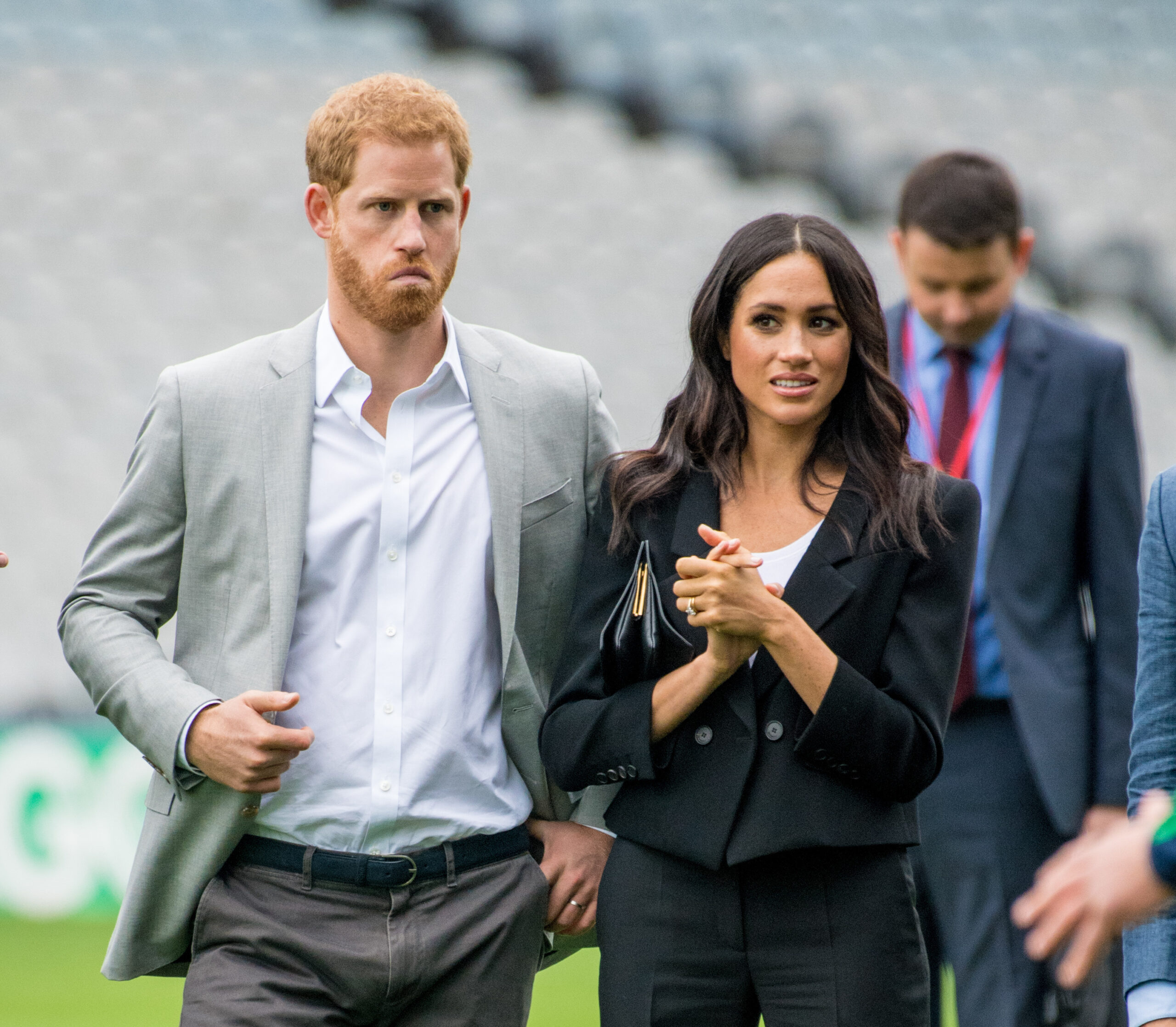 Prince Harry looks downcast as he joins Meghan Markle