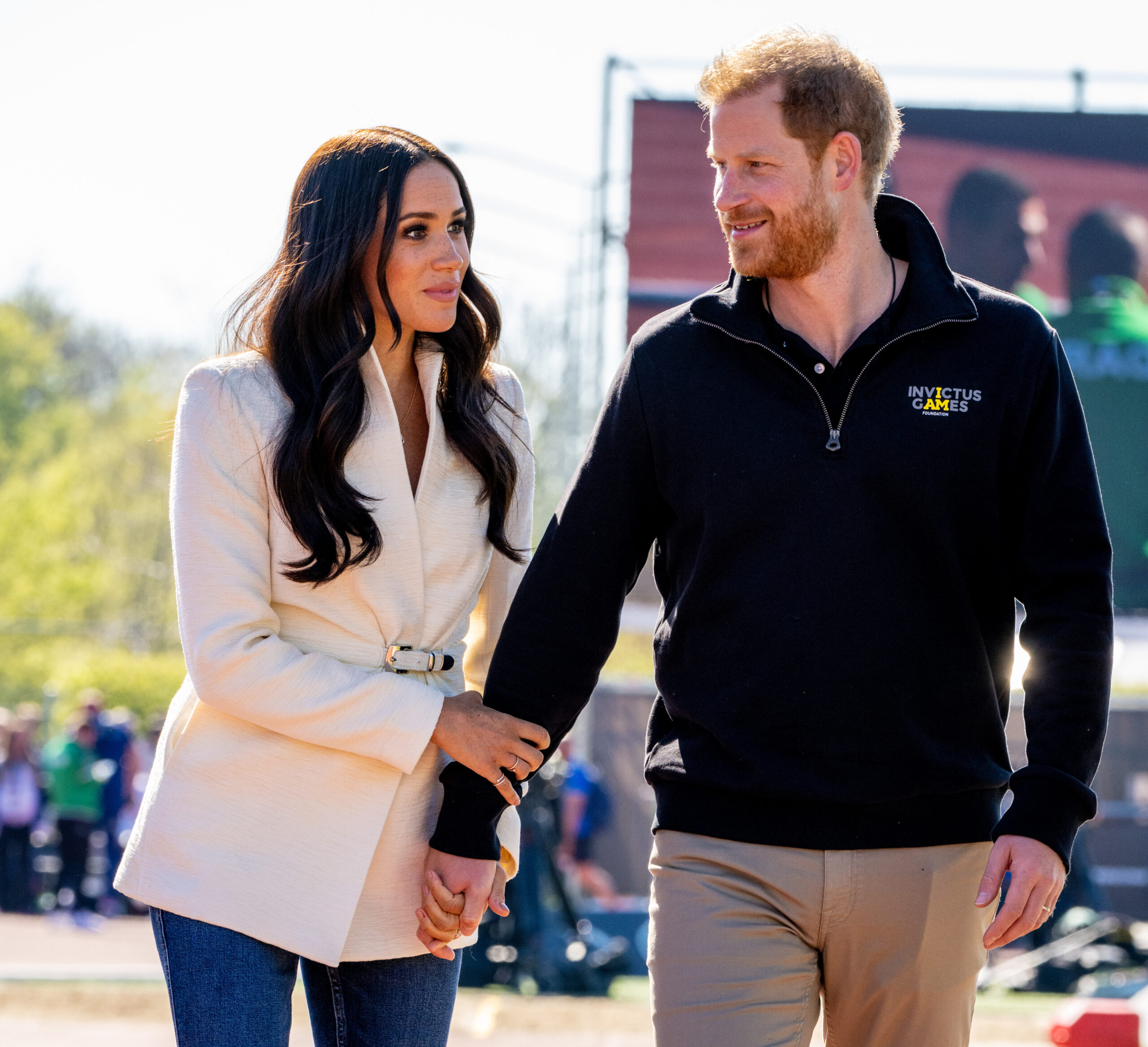 Meghan and Harry hold hands