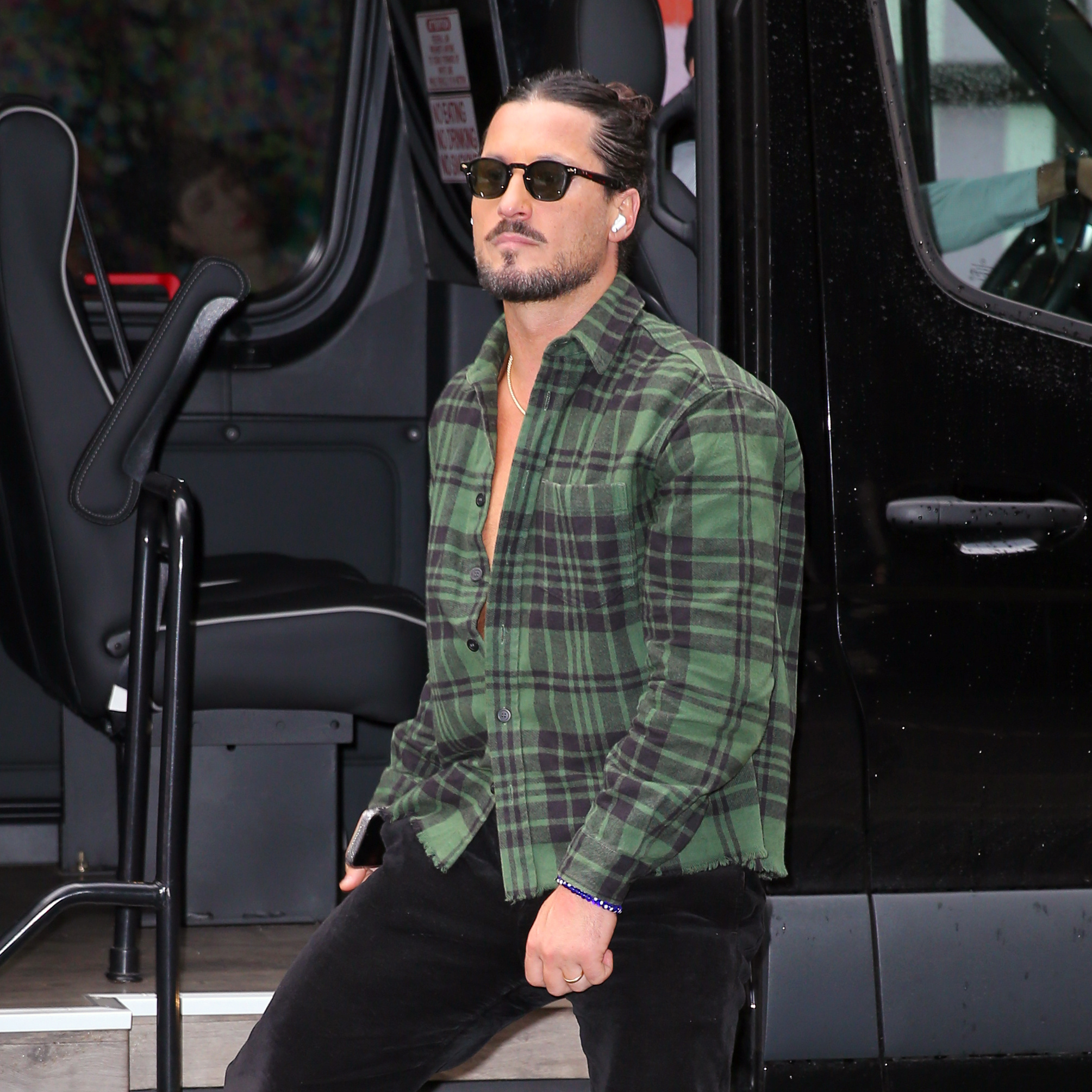 Val Chmerkovskiy walks along with earphones in