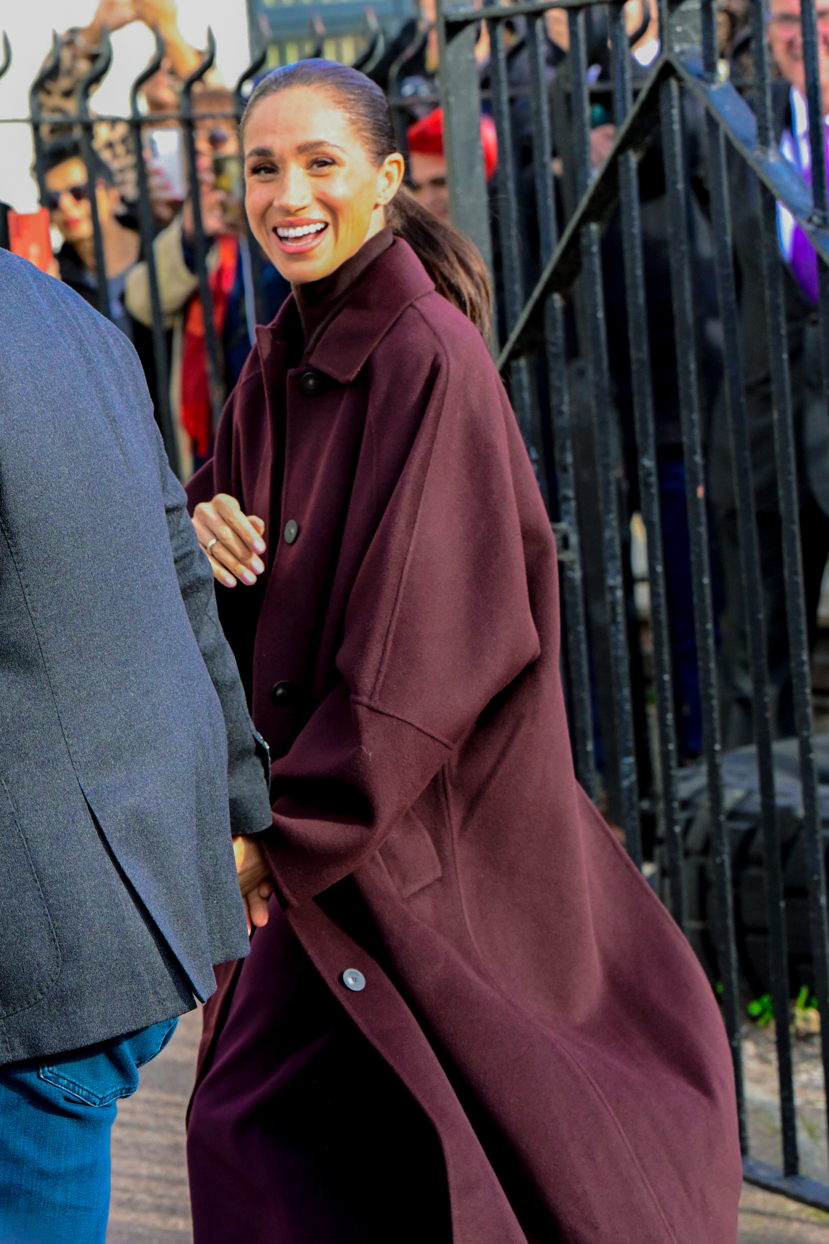 Meghan Markle in burgundy coat in Nottingham