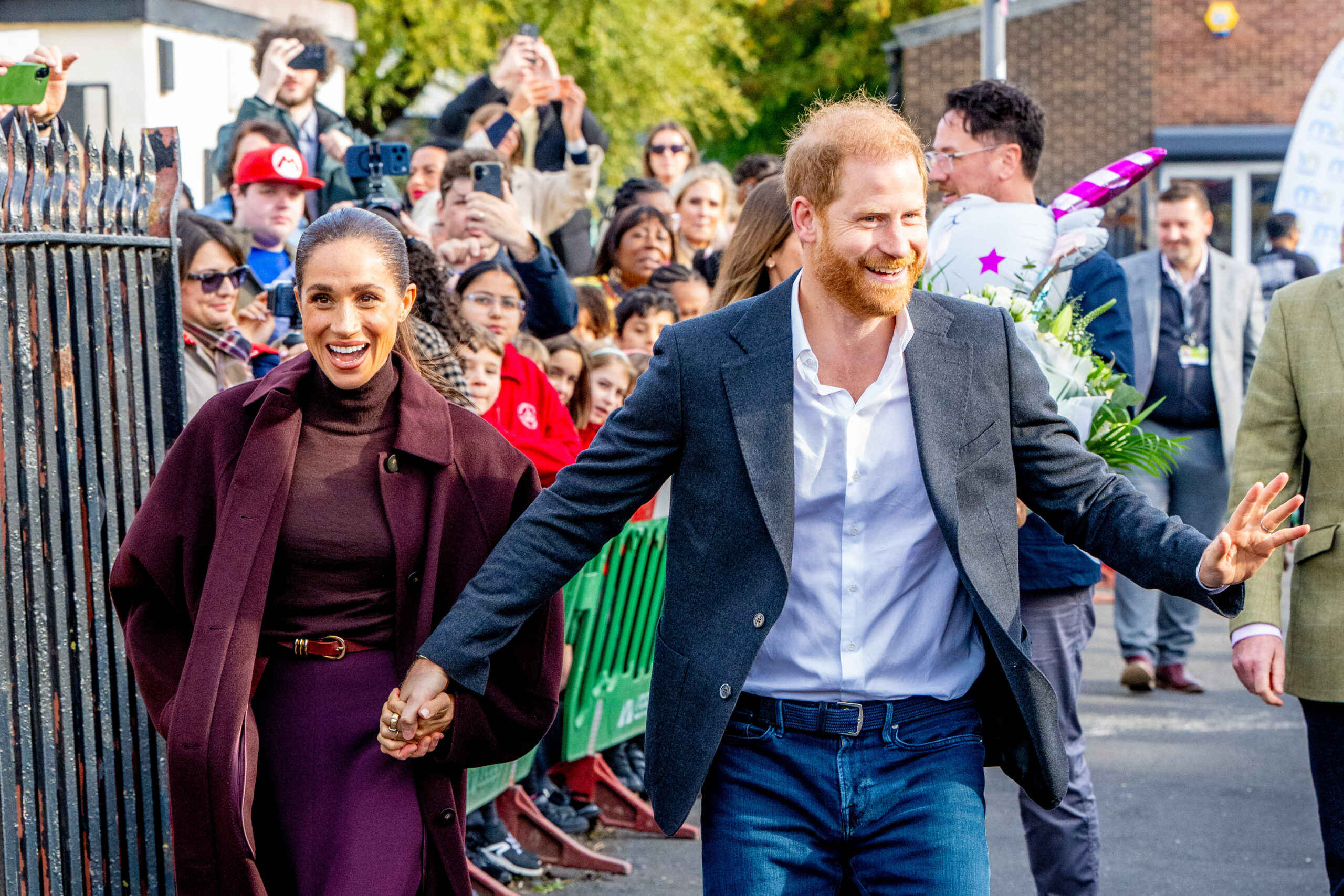 Prince Harry and Meghan hold hands at their first UK appearance together after moving back