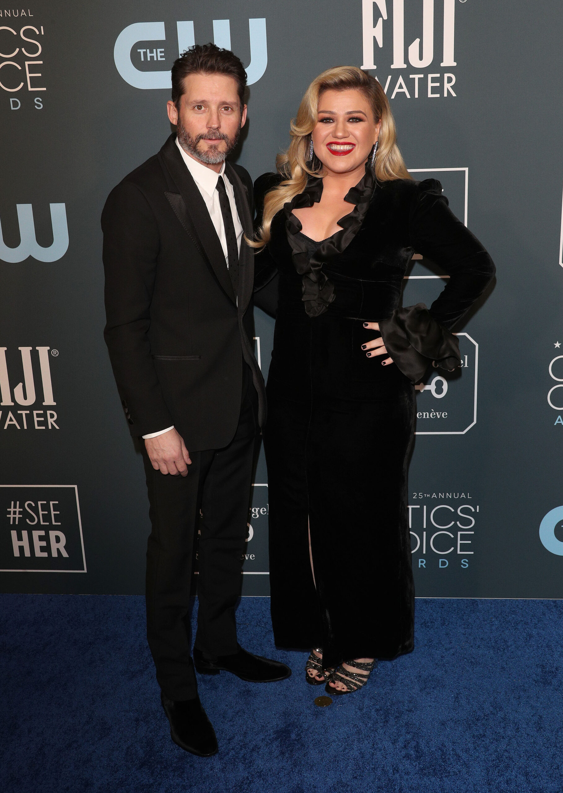 Brandon Blackstock and Kelly Clarkson smiling on the red carpet 