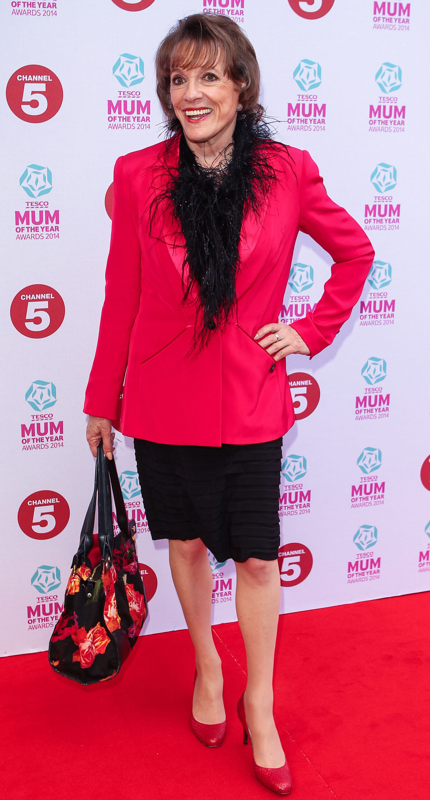 Esther Rantzen smiling in pink blazer