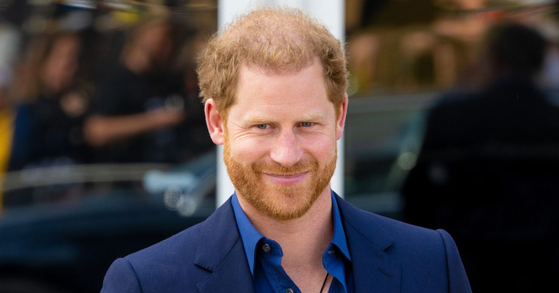 Prince Harry smiling at his first UK outing