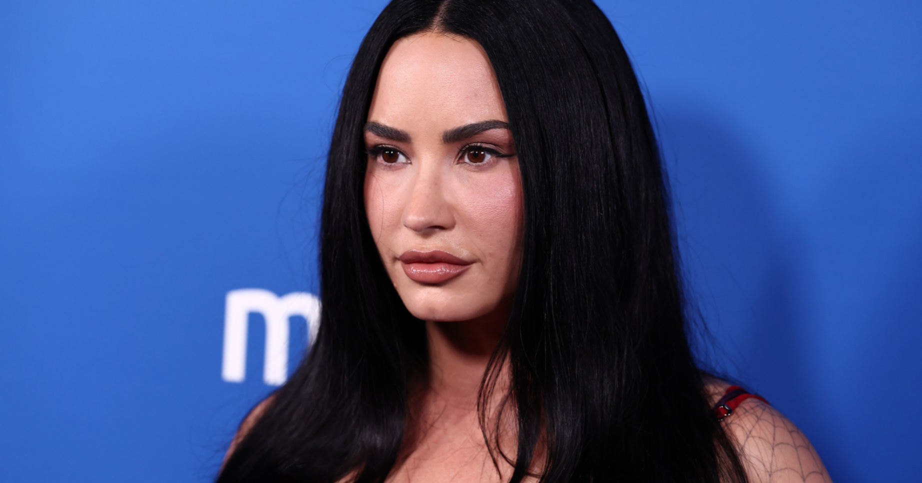 Demi Lovato looks at the camera dead pan